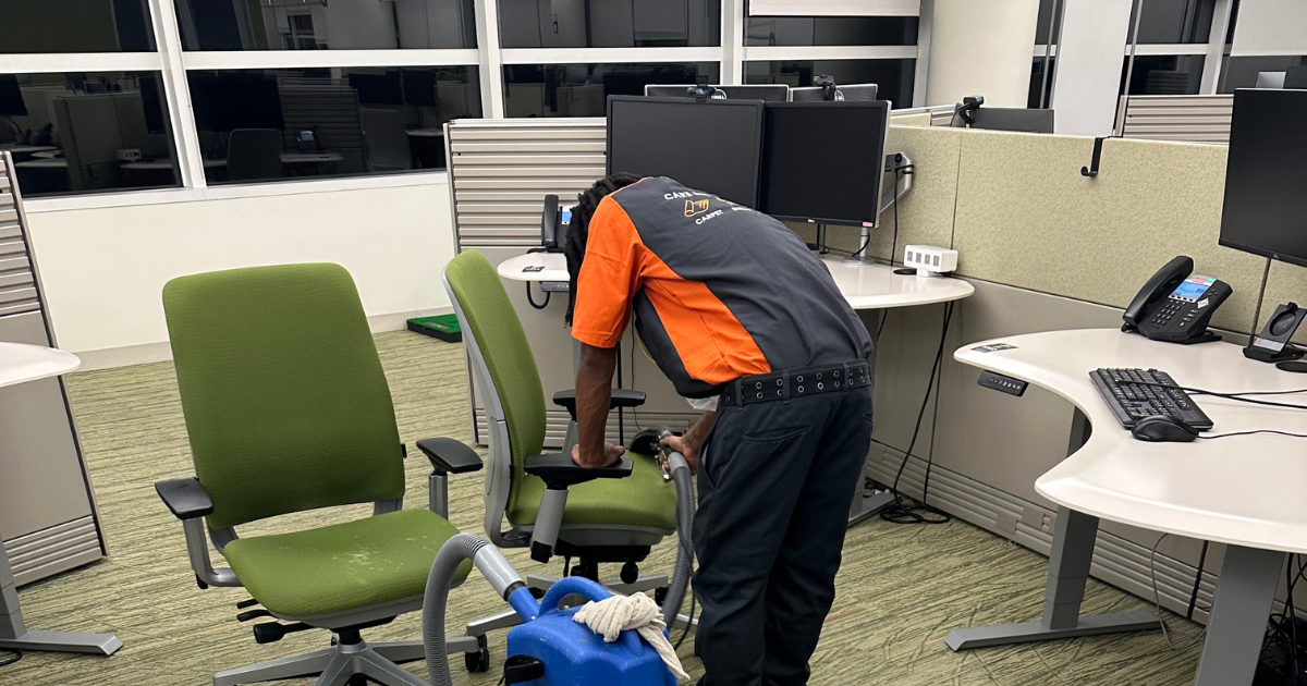 SOLID Surface Care technician in uniform cleaning upholstered office chairs in a corporate workspace