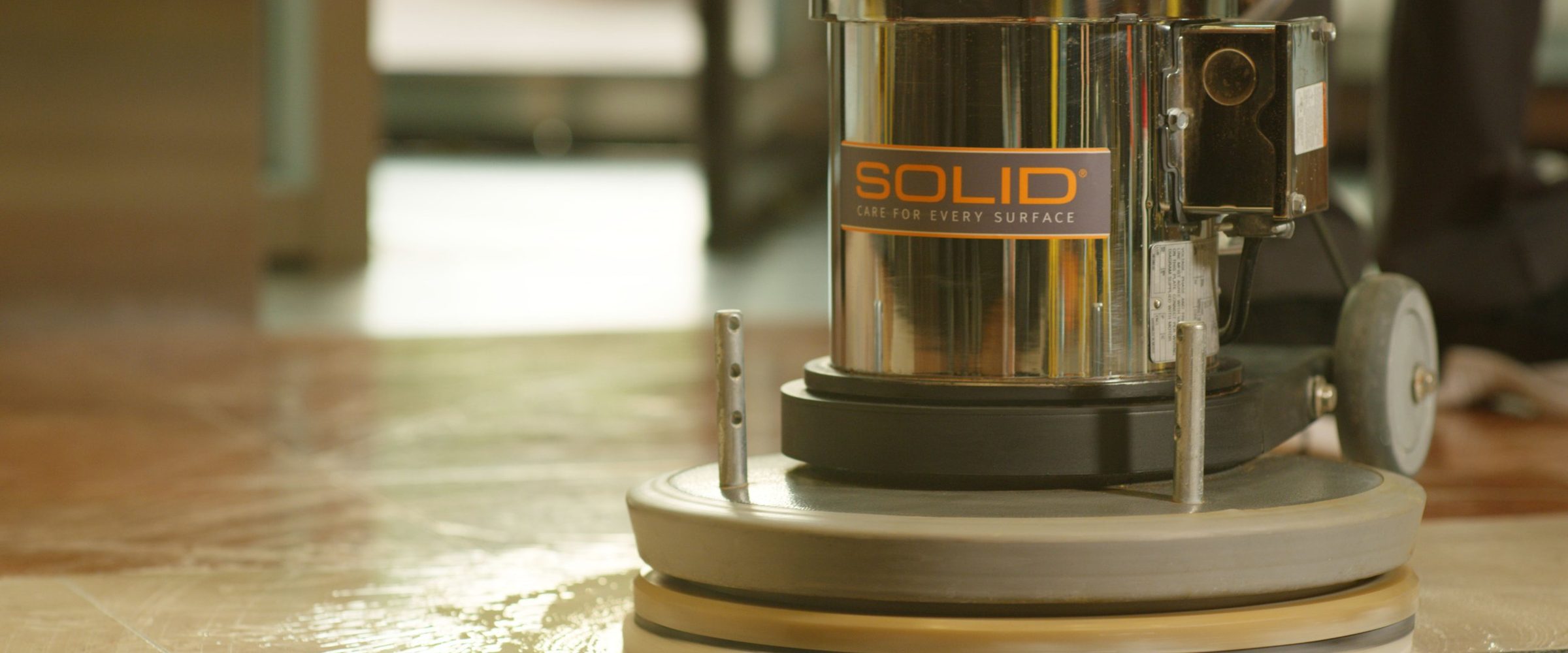 SOLID floor machine polishing a stone floor, labeled SOLID Care for Every Surface