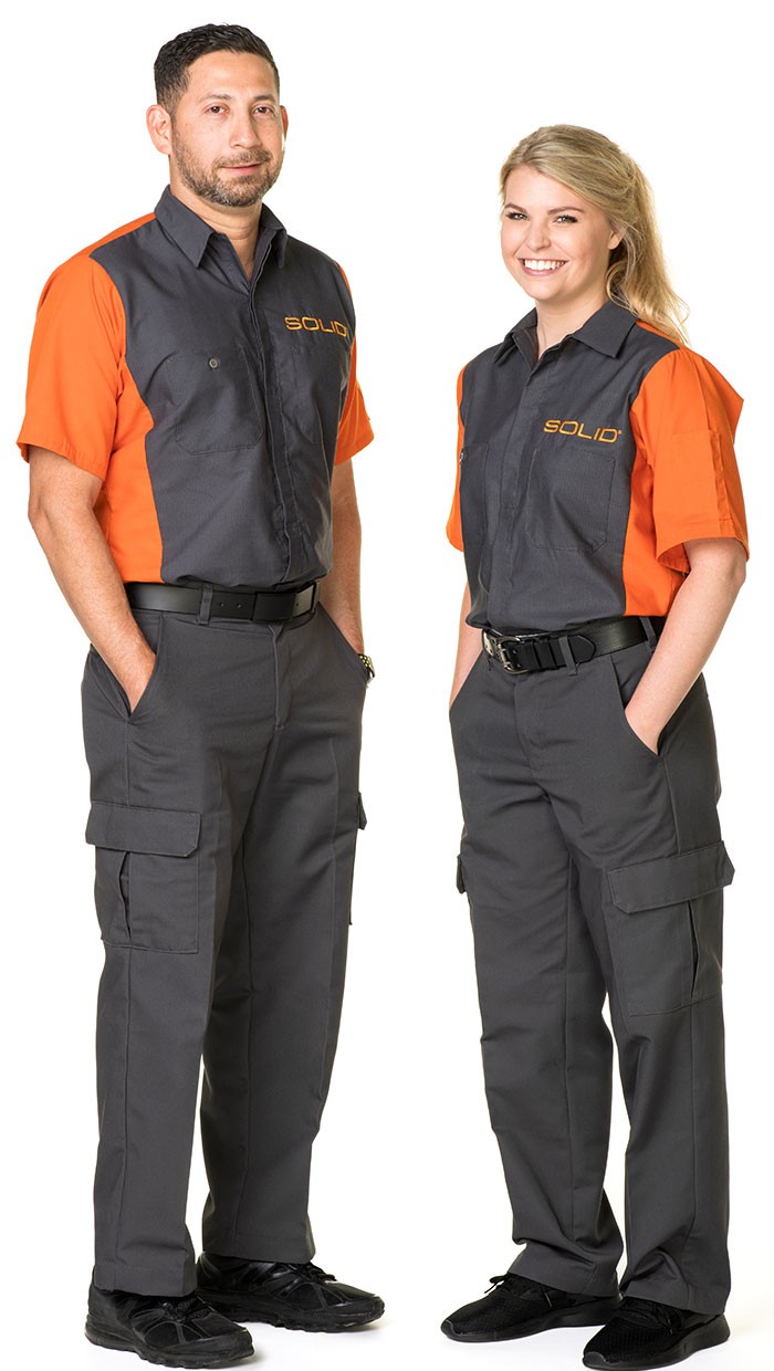 Two SOLID team members in the orange and gray SOLID uniform