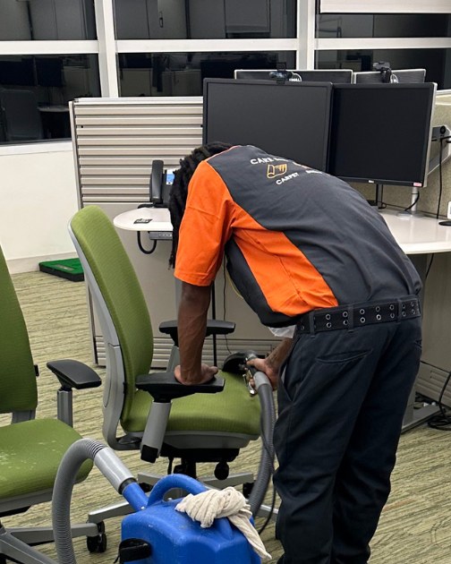 SOLID technician cleaning upholstered office chairs with an extraction machine
