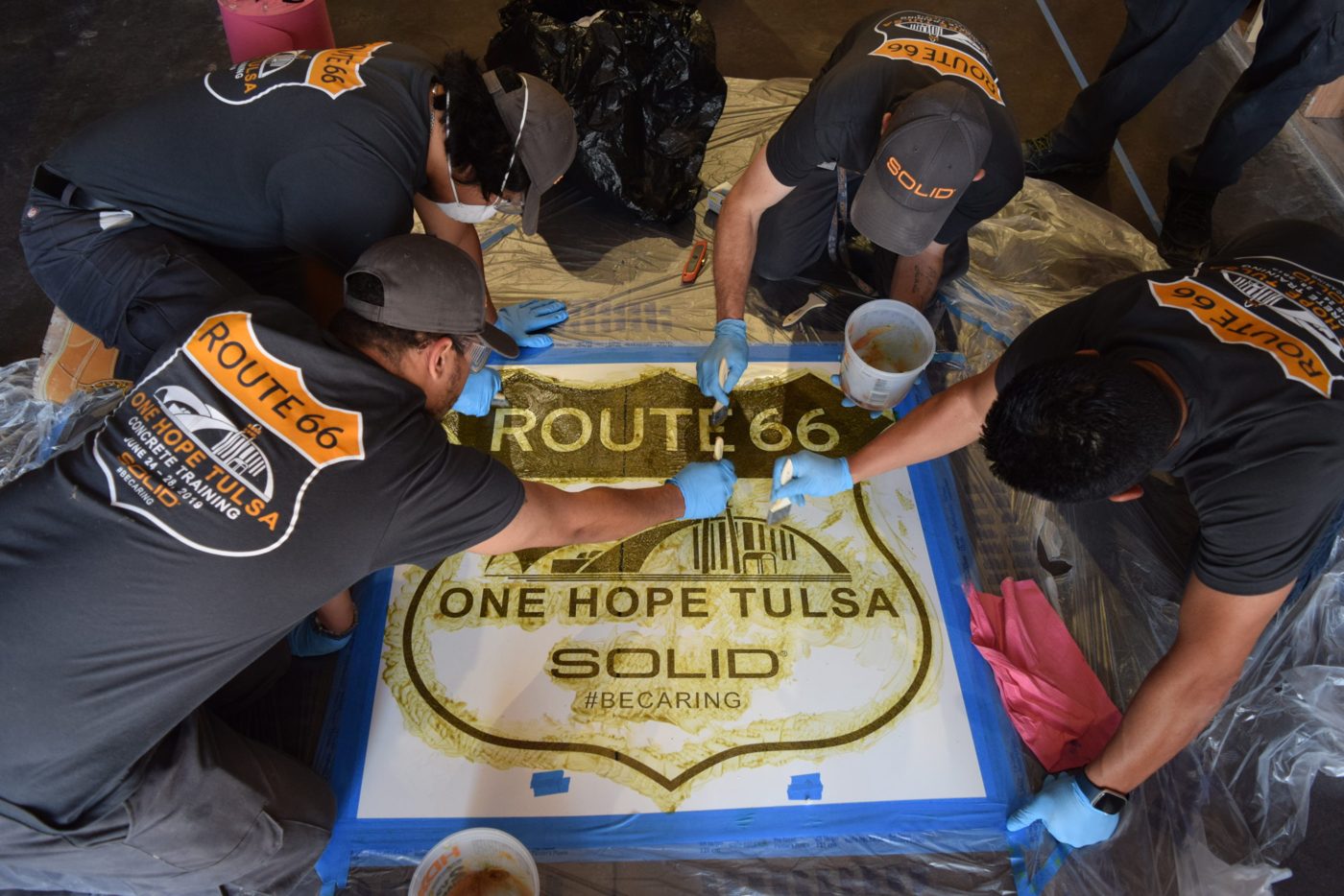 SOLID crew working together on a stenciled concrete floor during training in Tulsa